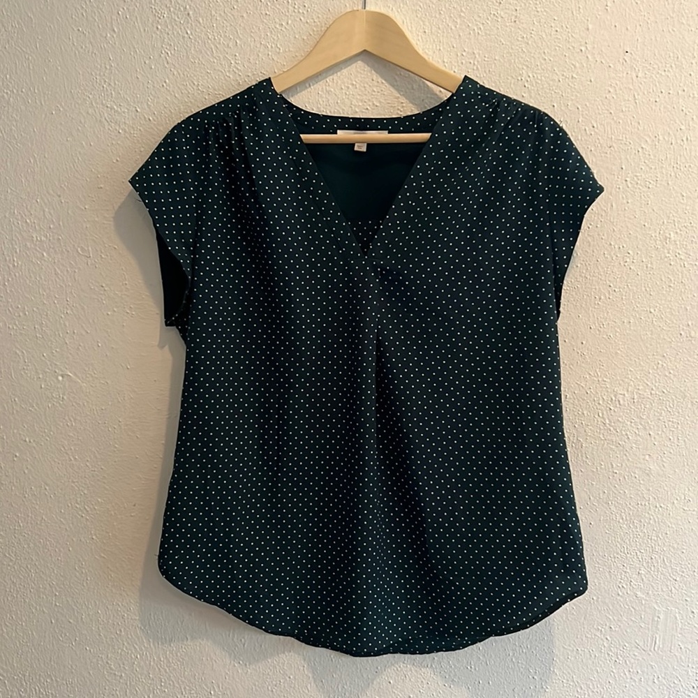Green blouse with white polk-a-dots, short sleeve, v-neck